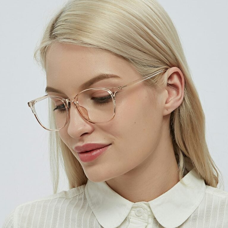 A woman wearing glasses and a white shirt