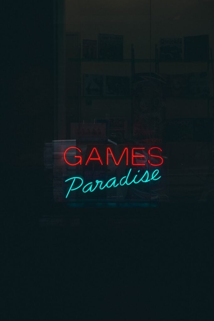 a neon sign that reads games paradise