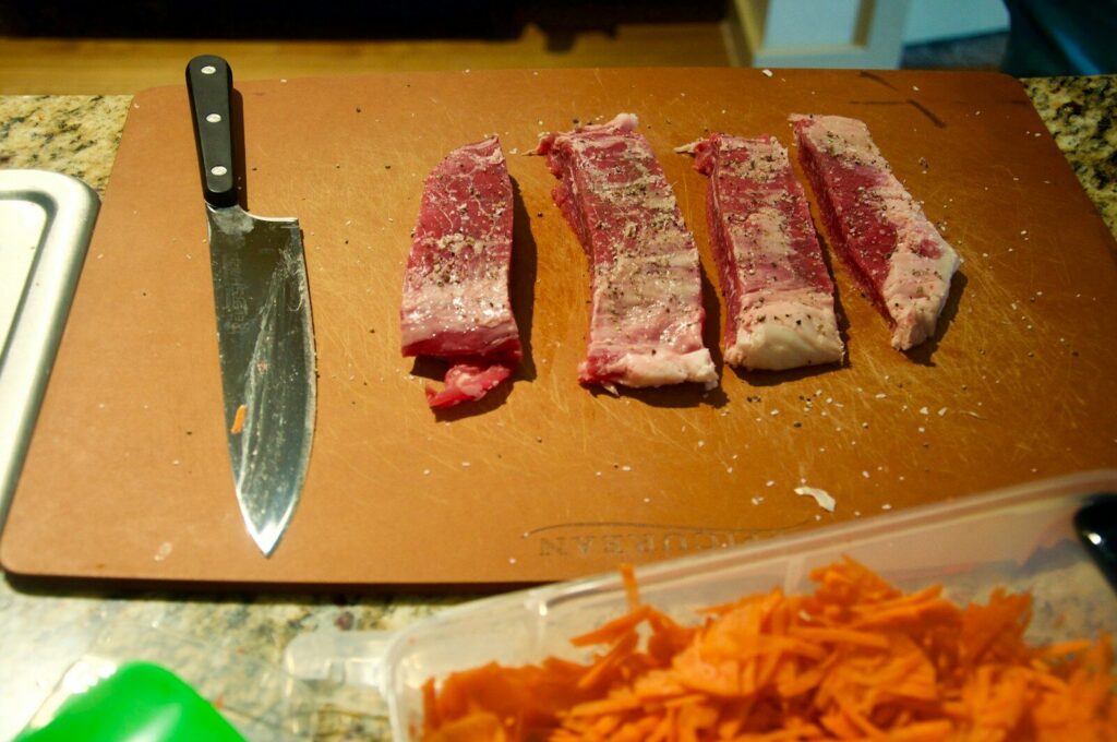 sliced meat on brown chopping board
