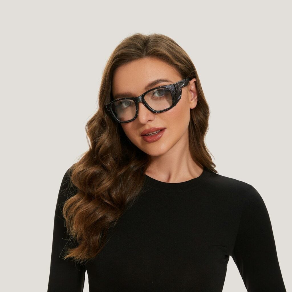 A woman wearing a black top and glasses