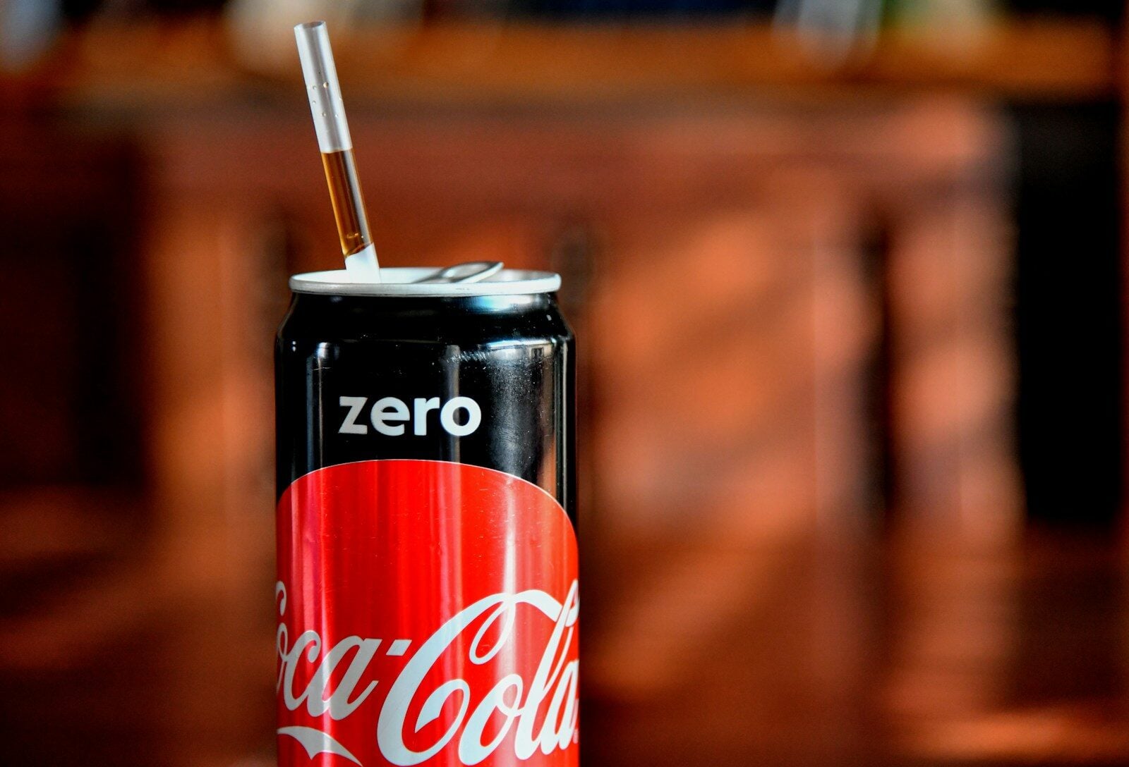 Coca-cola zero can with a straw